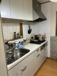 a kitchen with a sink and a counter top at Higashikurume station in Niiza City in Katayama