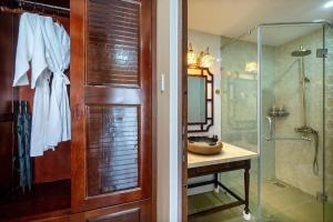 a bathroom with a glass shower and a sink at Zen B Hoian Villa in Cam Thanh +25 photos