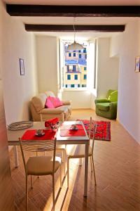 een woonkamer met een tafel en stoelen en een bank bij Vernazza Vacation 2 in Vernazza
