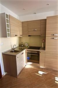 a kitchen with wooden cabinets and a sink at Vernazza Vacation 2 in Vernazza