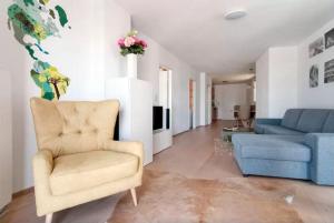 a living room with a chair and a couch at cosy apartment in the Viennese Gasometer in Vienna