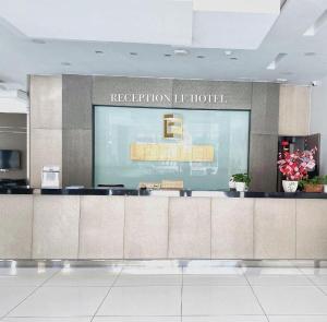 a hotel lobby with a reception counter in a building at LF Hotel Tapah in Kampar