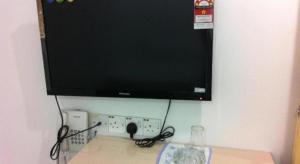 a flat screen tv hanging on a wall at Chin Yee Hotel in Teluk Intan