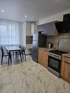 a kitchen with a table and a stove top oven at Новинка ЖК Тріумф поряд вокзалу in Luts'k +12 photos