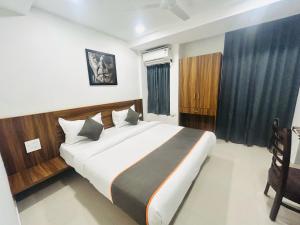 a bedroom with a large bed in a room at Hotel O SAI KRISHNA GUEST HOUSE in Kendrāparha