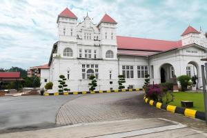 a large white building with a red roof at The Regency Hotel Seri Warisan in Taiping