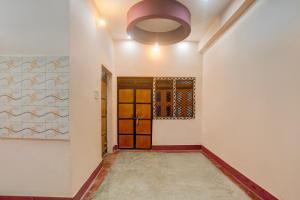 a hallway with a door and a window at SPOT ON Royal Hotel in Bhīta