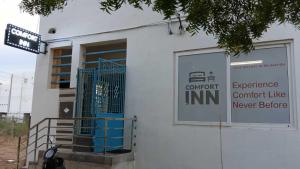 a building with a sign that reads entrance comfort like inn at Hotel O New Nest in Melappālaiyam