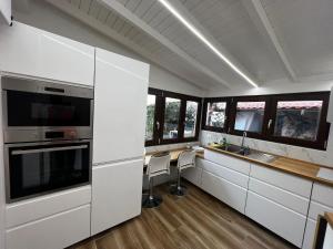 a kitchen with white cabinets and a table with chairs at Very nice flat in Lerici 5 terre Villa Aurora in centro con parcheggio in Lerici +39 photos