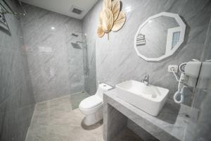 Un baño con lavabo, inodoro y espejo. en Ayodhya Villa Jogja, en Jetis 15 fotos más