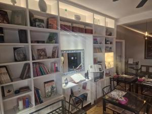 a room with a large white book shelf with books at Sweet Home Parioli in Rome