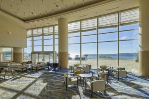 a large room with tables and chairs and large windows at Hotel Harvest Nankitanabe in Tanabe