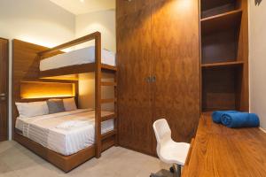 a bedroom with a bunk bed and a desk at Sparrow Villa - Kamala Beach in Kamala Beach +35 photos