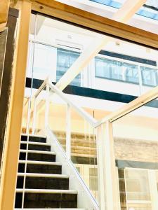 a staircase in a house with glass railing at Best Location, Luxury, 2 to 8 guest, SkyTV and More in Liverpool
