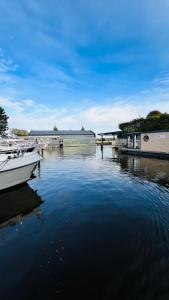 a boat is docked in a body of water at Rode Houseboat Zwartsluis in Zwartsluis