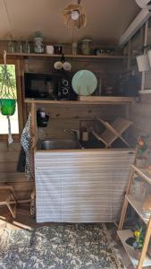 a kitchen with a sink and a counter top at Le chalet du bien-être in Vailhourles