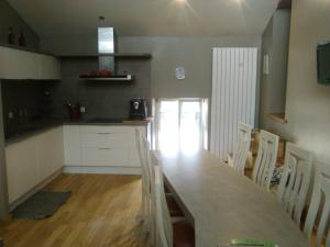 a kitchen with a long wooden table and chairs at la grange in Jeuxey +6 photos