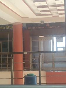 a view of a building with a pillar and signage at Hotel Teerth in Bahādrābād