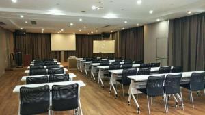 a conference room with black chairs and white tables and chairs at 7 Days Premium Chongqing Longtou Temple North Railway Station Center in Chongqing