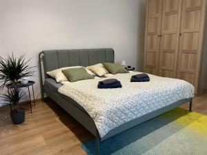 a bed in a room with two towels on it at Atlas suites WEST in Košice