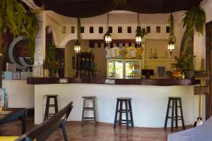 a bar in a restaurant with stools at MoovInn Garden Guesthouse in Ko Tao