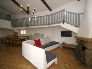 a living room with a white couch and a staircase at Spacious villa with garden near Grasse in Mouans-Sartoux