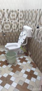 a bathroom with a toilet in a tiled floor at Moon house in Bodh Gaya