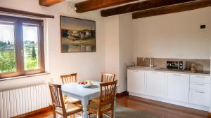 a kitchen with a table and chairs in a room at Città della Pieve Retreat in Città della Pieve