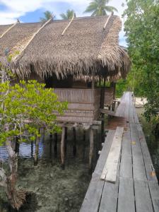 a hut on a dock in the water at Seawhip Homestay in Minyaifuin