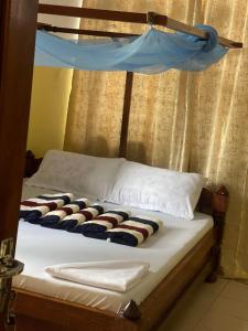 Ένα ή περισσότερα κρεβάτια σε δωμάτιο στο Epic Malaika