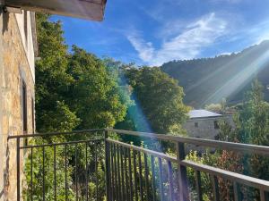 a balcony with a view of trees and sunshine at Entrenogueras in Huerta del Marquesado