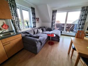 a living room with a couch and a table at Ferienwohnung Weitblick Breege in Breege