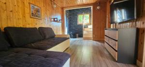 a living room with a couch and a dresser at Mój Domek z kominkiem i jacuzzi na wyłączność in Wisła