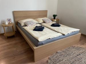 a bedroom with a bed with two pillows on it at Atlas suites EAST in Košice