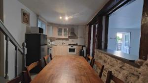 a kitchen with a long wooden table and chairs at Gite Centre Montbazon in Montbazon