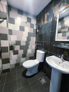 a bathroom with a toilet and a sink at Boutique Hote123 in Kuala Lumpur