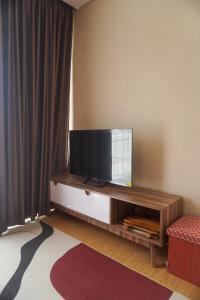 a living room with a flat screen tv on a entertainment center at Villa DeValley A9 Batu in Tlekung