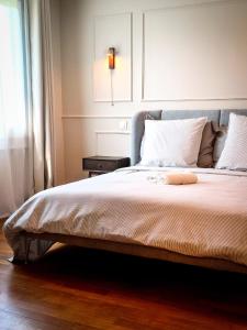 une chambre avec un grand lit avec une tête de lit bleue dans l'établissement Villa Hortensia - Charming Cottage Near Fontainebleau, à Veneux-les-Sablons