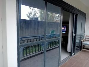 a sliding glass door to a balcony with a fence at Zuri apartment in Lwero