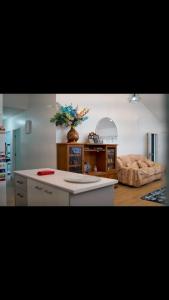 a kitchen with a table and a couch in a room at Lina and Fanga's holiday home in Kolomotua +29 photos