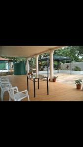 a group of chairs and a table in a pavilion at Lina and Fanga's holiday home in Kolomotua