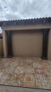 a room with a wall with a tile floor at Akwaaba Fie Guesthouse in Lebowakgomo +3 photos