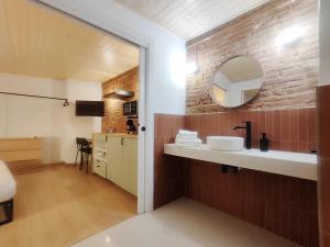 a bathroom with a sink and a mirror at Mazi Plaça Gran in Mataró +26 photos