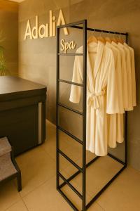 een kast met een rek aan witte kleding bij Adalia House Medimurje Private Wellness Nature View & Wine Region in Štrigova