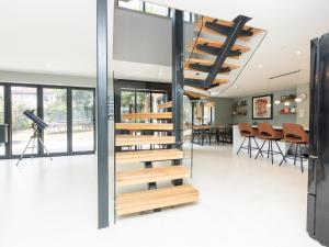 a staircase in the middle of a room with a camera at Pass the Keys Stunning home with private parking in Bath in Bath