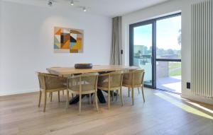 a dining room with a wooden table and chairs at Stunning Home In Durbuy With Sauna in Tohogne