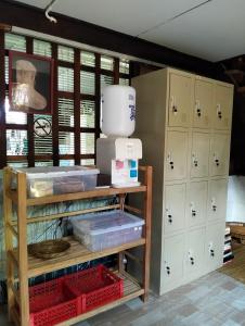 a kitchen with white cabinets and a shelf with boxes at Imchai in Pai +70 photos