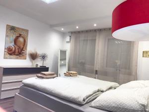 a bedroom with a large bed and a mirror at FeWo Wagner in Fuggerstraße in Dillingen an der Donau