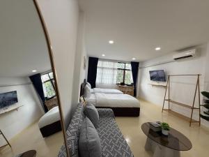 a living room with a bed and a couch at Sukhumvit 48 separated room quiet and comfortable with fast internet and smart TV in Bangkok