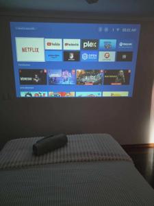 a bed with a remote control on top of it at Beautiful Holiday Home in Gold Coast +9 photos